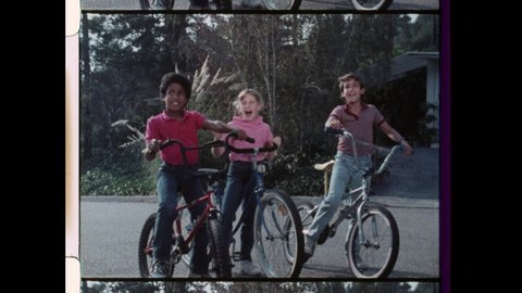 1980s Hawkins, Indiana. Three Kids on BMX and Schwinn Bicycles Wave to Women in a Field. 4K Overscan of Archival 16mm Film Print