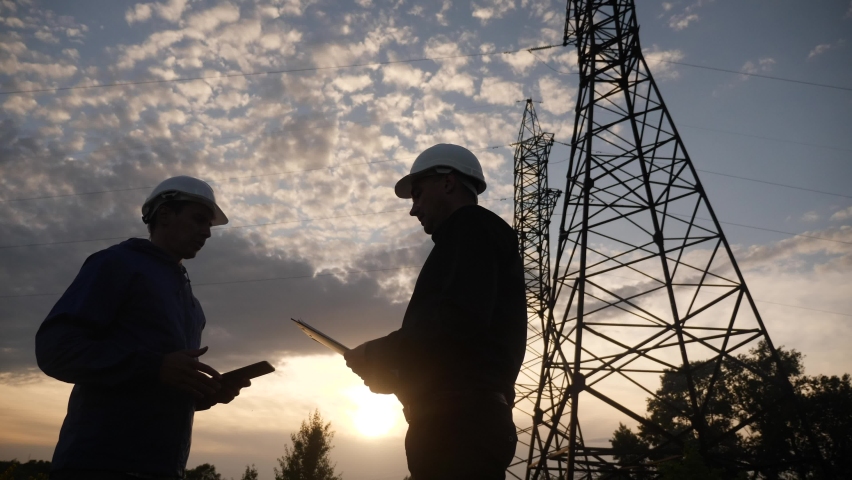 teamwork. two electricians engineer shake hands. business partnership energy technology industry a concept. silhouette two workers handshake. teamwork lifestyle in energy Royalty-Free Stock Footage #1062177727