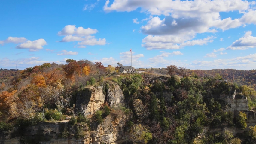 House with American flag on the pole at the top of the mountain. Stunning aerial view of a house at the top of the mountain of Granddads Bluff in La Crosse, Wisconsin