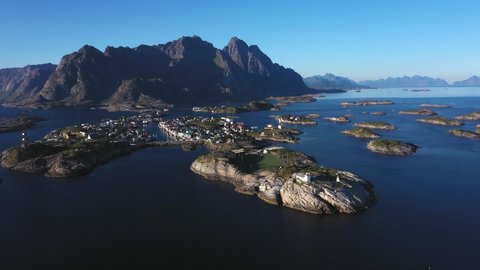 Aerial view around the Henningsvaer town, sunny, summer evening, in the Lofoten archipelago, Norway - circling, drone shot