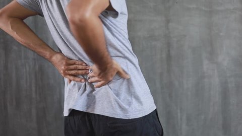 a young man suffering from back pain