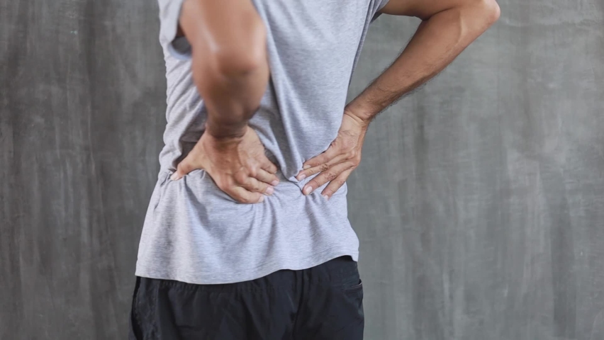 Young man suffering from back pain, have a backache, health problems | Shutterstock HD Video #1062184741