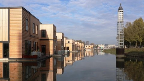 A row of floating homes located in Rotterdam Nassauhaven port. Innovative sustainable living in a city threatened by rising sea levels.
