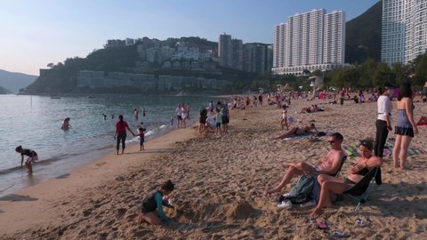 Hong Kong , Hong Kong Island / China - 11 07 2020: People enjoying the evening at Repulse Bay beach in Hong Kong as public beaches reopening, after months of closure amid coronavirus (Covid-19) 