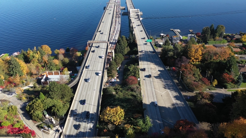 Aerial / drone footage of East side of Seattle, the I-90 bridge, Roanole, Mercer Island Town, Lake Washington and surrounding suburbs in King County, Washington