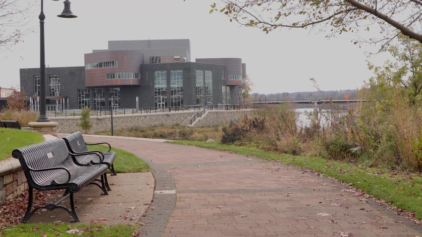 Empty park benches on a trail bend in a park. Phoenix Park in Eau Claire Wisconsin
