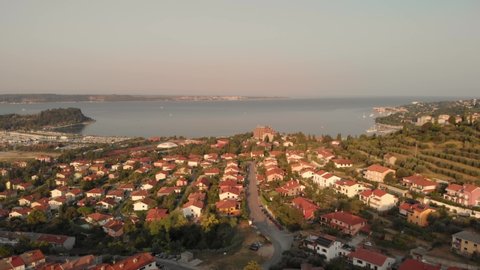 This is a 4k drone reveal shot of the beautiful city piran in slovenia. It was in the morning close to sunrise. In the background is a port and a bay to the adrian sea.