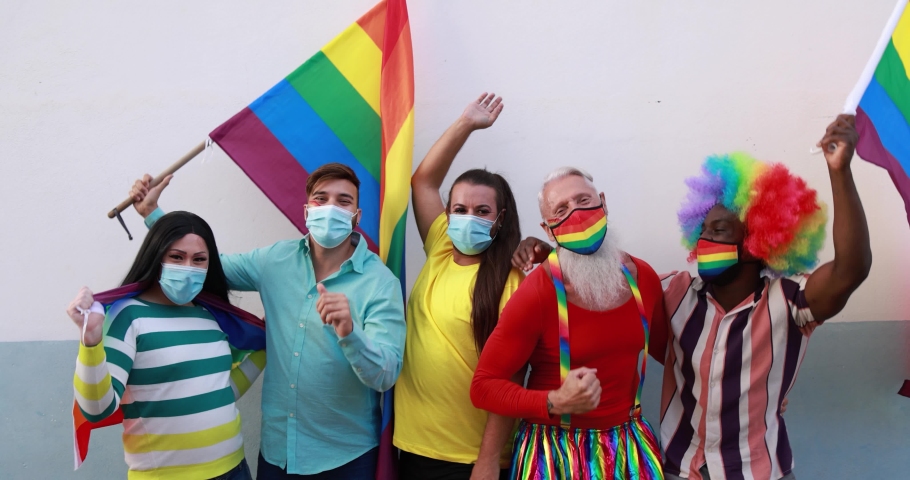 Gay people dancing outdoor while wearing face masks during coronavirus outbreak - Party and pride concept - Slow Motion
