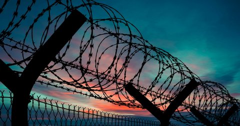 Barbed Wire Border Fence Silhouette Red Sky at Dusk Timelapse Barbed Wire Time Lapse