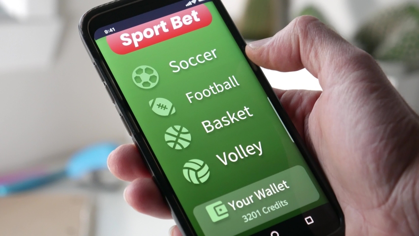 Placing a sports bet online on a smartphone app. Choosing which team will win and betting online. Gambling money on Internet. | Shutterstock HD Video #1062204283