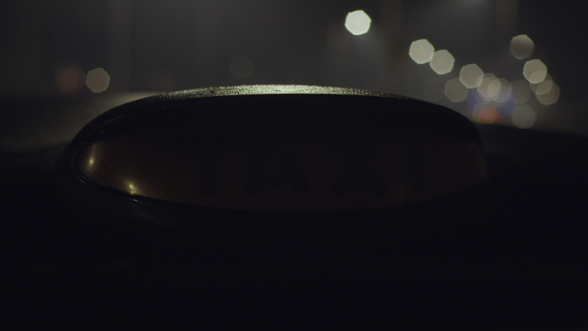 A closeup shot of a london black taxi light turning on at night with a beautiful bokeh background. Perfect for travel films, montages, london based videos and more. In stunning 4K. Royalty-Free Stock Footage #1062209374