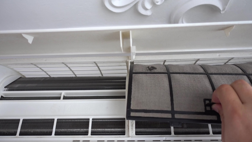 Removing the dust filters on the air conditioner for washing and cleaning. Concept for maintenance of hygiene and pure air to prevent allergies and breathing problems.. Air conditioner net being taken | Shutterstock HD Video #1062212680