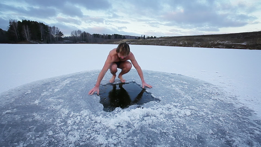 Winter swim. Young man with beard swims in a winter lake. Scene 1, camera 1 Royalty-Free Stock Footage #1062213130