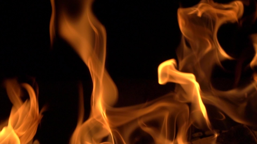 Slow-motion video of fire and flames.A fire pit, burning gas or gasoline burns with fire and flames.Flames and burning sparks close-up,fire patterns.A hellish glow of fire in the dark with copy space | Shutterstock HD Video #1062213196
