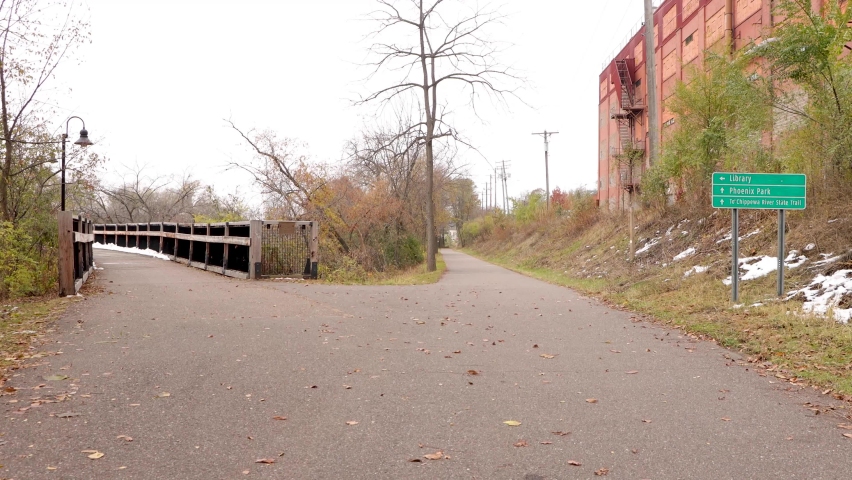 Crossroads with a sign leading to the river trail. Chippewa Falls State Trail in Eau Claire, Wisconsin.