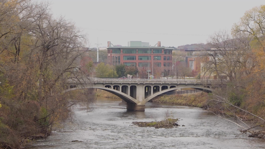 Stone bridge crossing a dark fast river. The bridge crossing Chippewa River in Eau Claire, Wisconsin