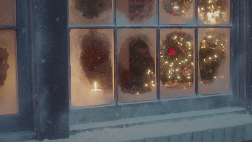 A lit christmas tree is visible through the snow frosted window panes Royalty-Free Stock Footage #1062214747