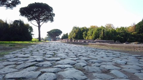 Roman road stone-paved at the entrance of Ostia Antica, a world famous archeological site.