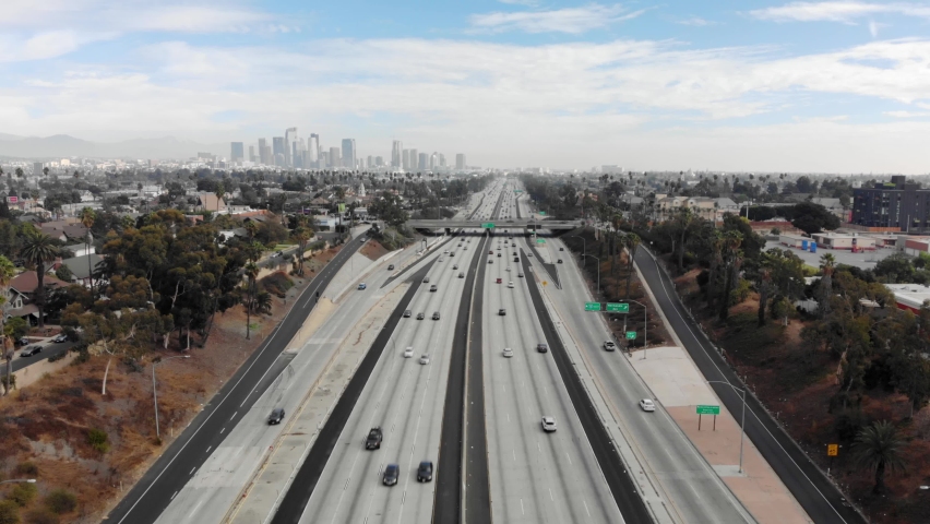 Aerial view flying over interstate 10 with traffic looking at downtown Los Angeles, sunny day, in Los Angeles, California, USA