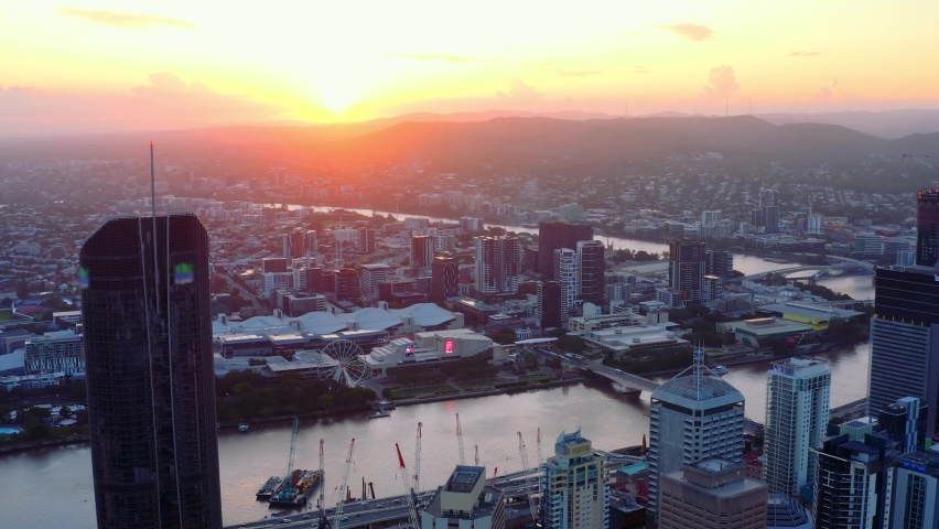 Sunset Over Brisbane City And River Surrounded By High-rise Buildings In Queensland, Australia. - aerial drone shot