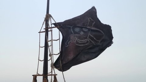 ripped tear grunge old fabric texture of the pirate skull flag waving in wind, calico jack pirate symbol, dark mystery style, hacker and robber concept