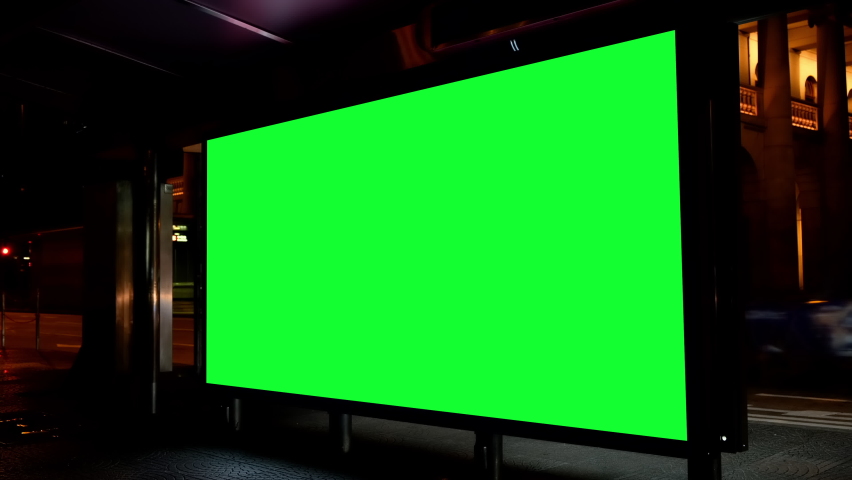 Night city street billboard stand with green screen. Green screen for text or copy. Royalty-Free Stock Footage #1062220990