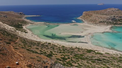 Beautiful aerial shot of the picturesque view of Balos Beach Lagoon in Crete, Greece - ocean horizon against blue skies in background.