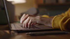Hand of woman using laptop computer to work, typing at home, while sitting on table workplace at night, Close-up of young women hand - Powered by Shutterstock - Get 15% off with code: PIKWIZARD15