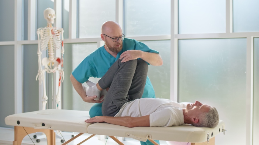 The Patient Uses Physical Therapy to Recover from Surgery and Increase Mobility. The Doctor Works on Specific Muscle Groups or Joints. Freedom from Chronic Back Pain | Shutterstock HD Video #1062235843