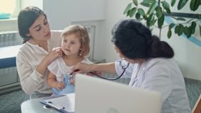 Female Doctor Pediatrician Using Stethoscope Listen to the Heart of Happy Healthy Cute Kid Girl at Medical Visit With Mother in the Hospital. Female Doctor Examining Child. - Powered by Shutterstock - Get 15% off with code: PIKWIZARD15