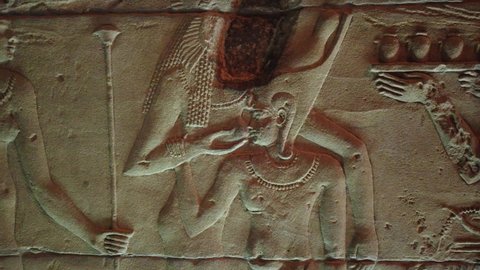 An image carved on the walls of the ancient and historical Philae Temples complex in Aswan of the god Isis while feeding from his mother. Breastfeeding of the Pharaohs.