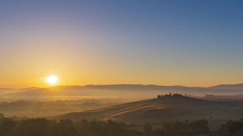 4K Panning Timelapse Sunrise over the rolling hills in Tuscany countryside, Italy
