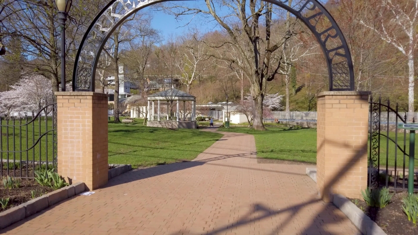 Boom rising in front of Berkeley Springs Park sign in rural WV town.