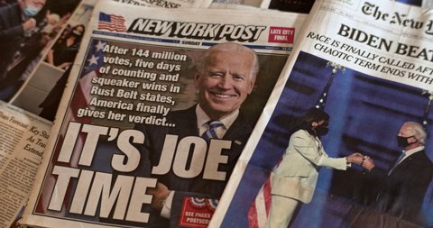 Staten Island, New York  United States - November 8 2020: Newspaper coverage of Joe Biden being declared winner of the 2020 Presidential Election. Pan of front page of various newspapers.
