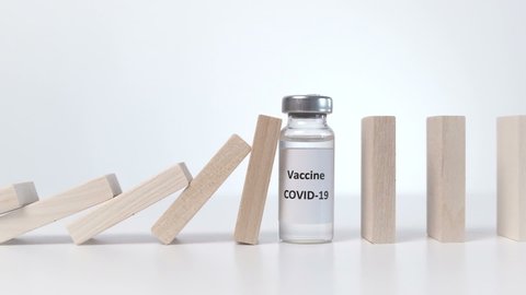 Vaccine of COVID-19 stop the Falling Domino. Slow Motion, Selective Focus
