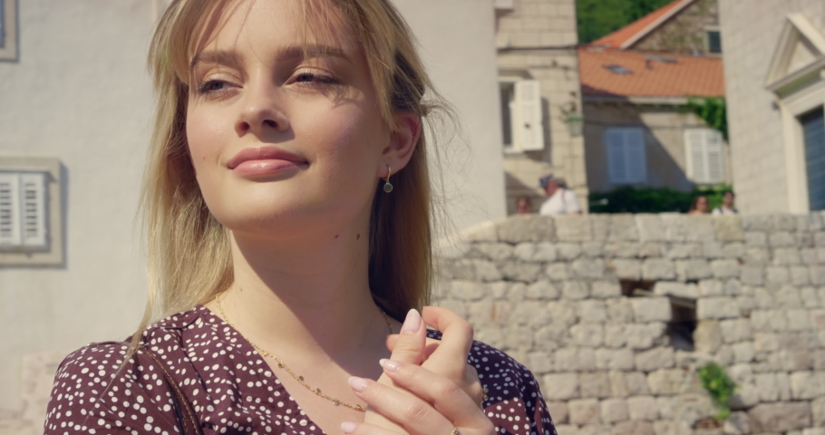 Stunning caucasian girl catching the sun while sightseeing the old town in Croatia RED Epic Dragon 6K