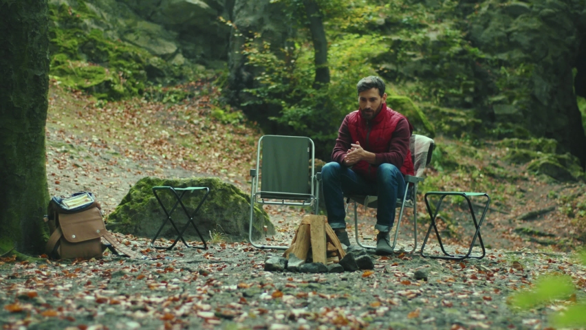 Happy father and son speaking sitting in autumn woods. Child smiling fall leaf environment relaxation. Close up. Slow motion