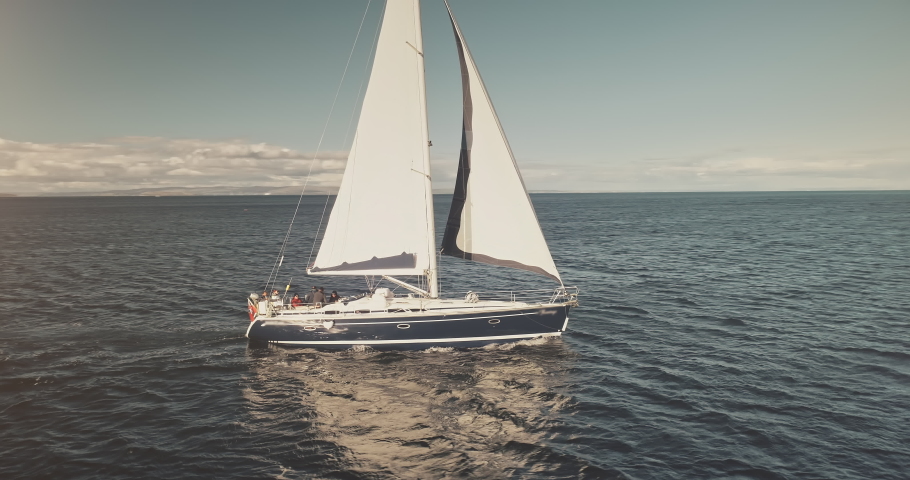 Sun seascape with white sails yacht in open sea aerial. Sailing on sailboats at ocean bay. Luxury yachting lifestyle at summer sunny day. Cinematic serene, calm and relax concept Royalty-Free Stock Footage #1062272725