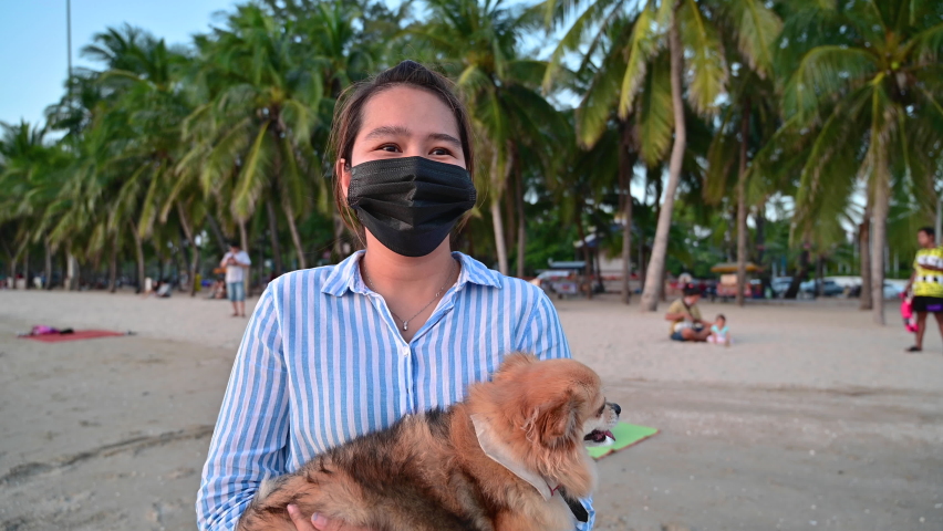 Young woman with protect face mask travel at the beach in Thailand