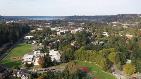 Aerial / drone footage of Issaquah, Olde Town, Newport, Issaquah Highlands, the I-90 highway, commercial area, Lake Sammamish and surrounding suburbs in King County, Washington