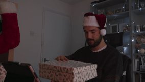 Male shocked and laughing opening Christmas present which lights up face