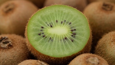 kiwi fruit. heap sliced and whole kiwi fruit close up, rotating