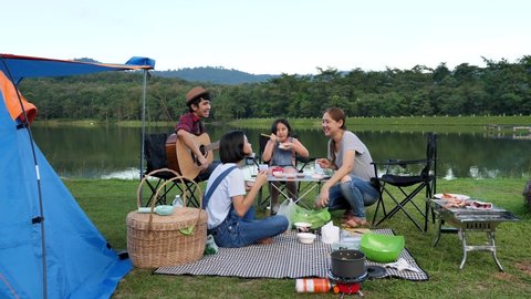 Happy Young Asian Family Sitting Together At Lake Side Camping. Family Relationship Activity.
