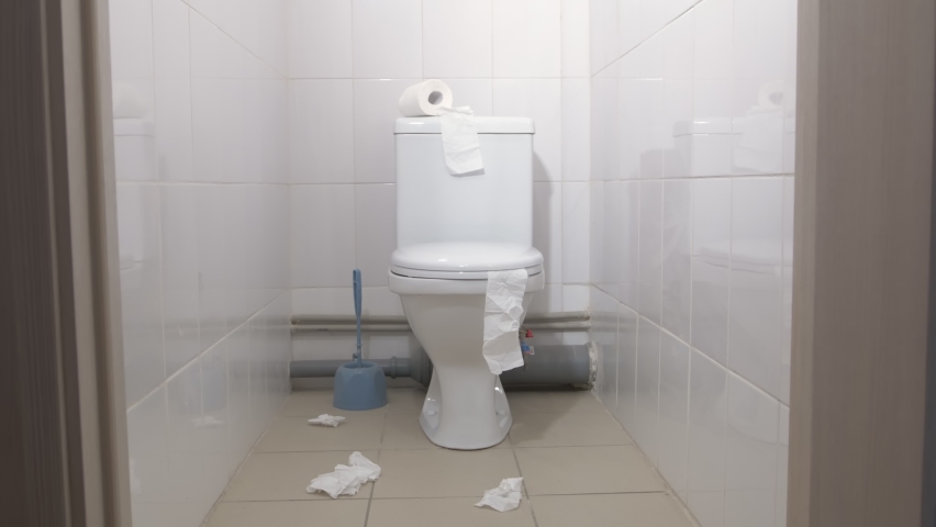 Toilet room with white ceramic toilet in which there is nobody. Dirty room needs cleaning. Royalty-Free Stock Footage #1062281941