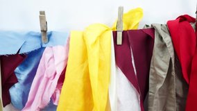 Pile of different colored clothes, closeup. Colorful background for fashion theme.
