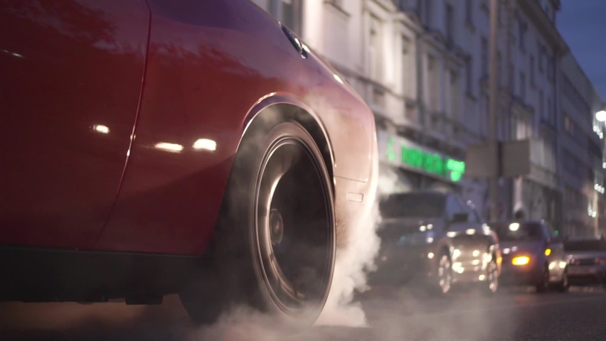 Car burns rubber off its tires in preparation for the race. Footage. Slow motion video of sport vehicles right back wheel the tire burns against the asphalt with smoke | Shutterstock HD Video #1062290035