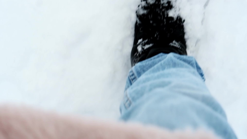 Legs of woman walking on snow with footprints on snowy day | Shutterstock HD Video #1062290938