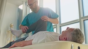 An Adult Man Trains Muscle Strength With a Professional Doctor in a Modern Rehabilitation Clinic. Physiotherapy Program, Rehabilitation After Medical Injuries. Healthcare Concept - Powered by Shutterstock - Get 15% off with code: PIKWIZARD15