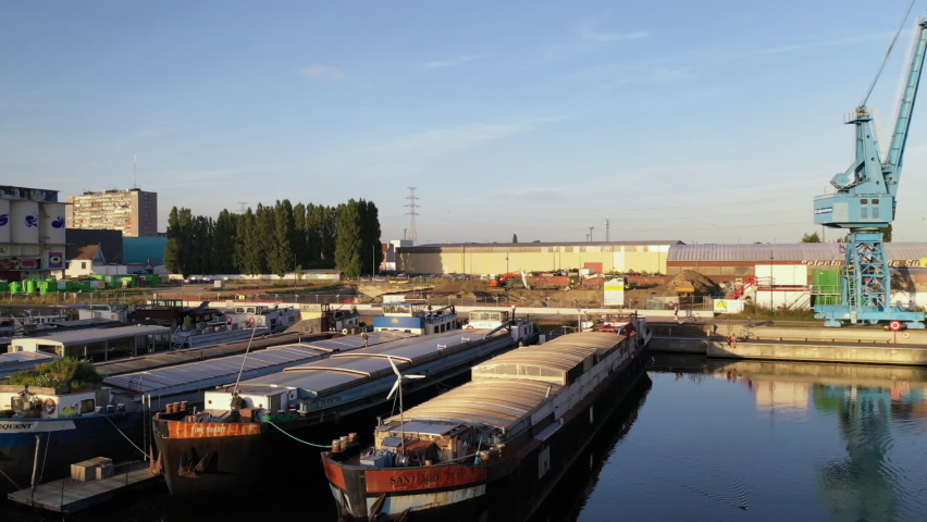 Aerial, panning, barges in the industrial district at sunrise, Gent, Belgium