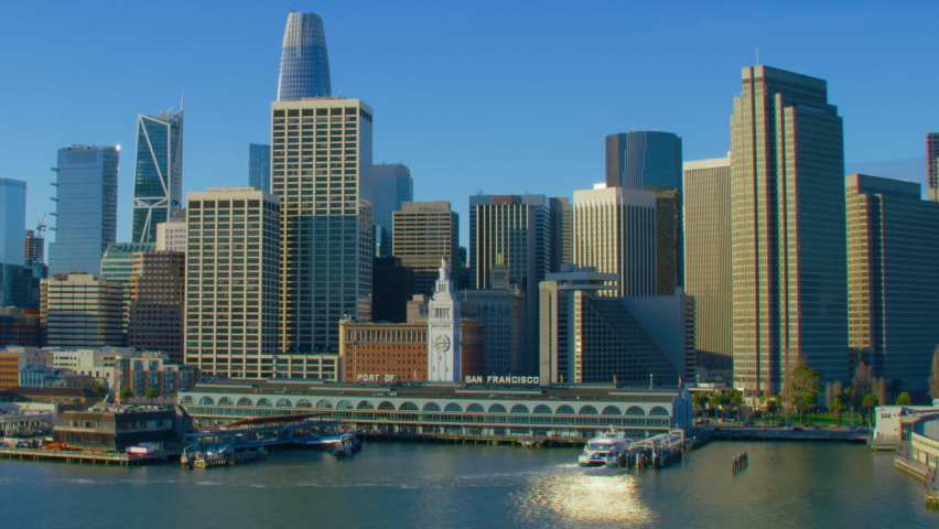 Aerial view of the San Francisco Ferry building with its clock tower. Famous buildings and piers. Financial District. Shot on Red weapon 8K. California, United States.